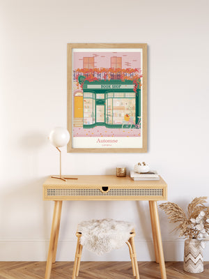 Affiche automnale "Boutique Littéraire – Automne en Ville" mise en scène dans un salon ou coin lecture, ambiance douce et feutrée.